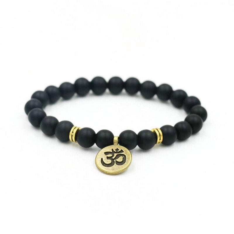Black beaded yoga bracelet with round gold-tone om charm and spacer accents