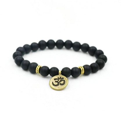 Black beaded yoga bracelet with round gold-tone om charm and spacer accents