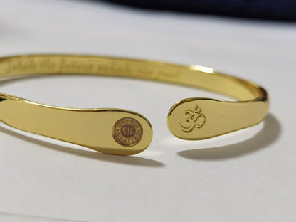 Gold yoga bracelet with engraved Om symbol and round stamped charm