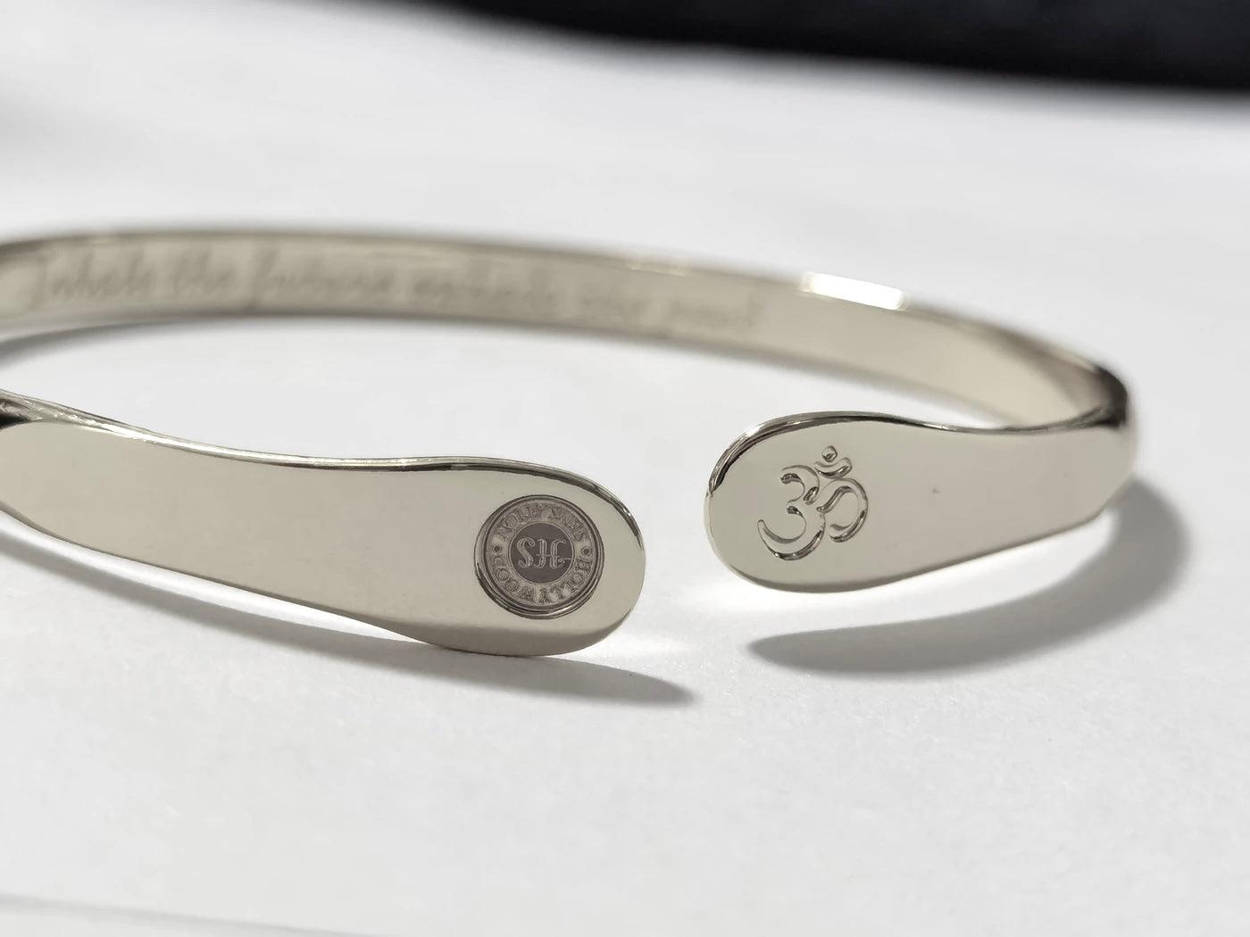 Silver yoga bracelet with engraved Om symbol and round stamped charm