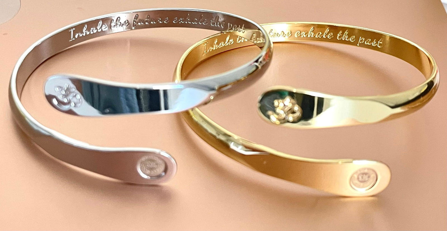 Set of silver and gold yoga bracelets with engraved Om symbols and side logo details