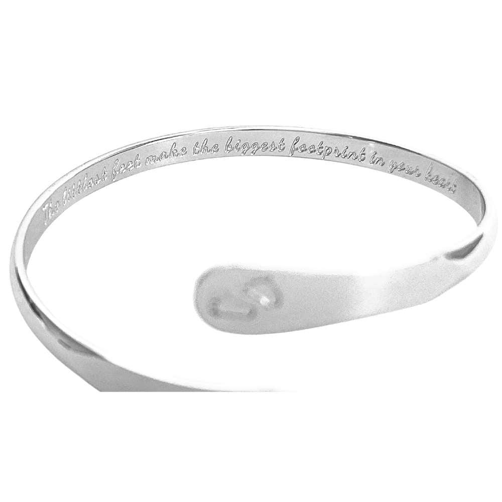 Silver baby footprint engraved bangle bracelet with small oval footprint charm at center.