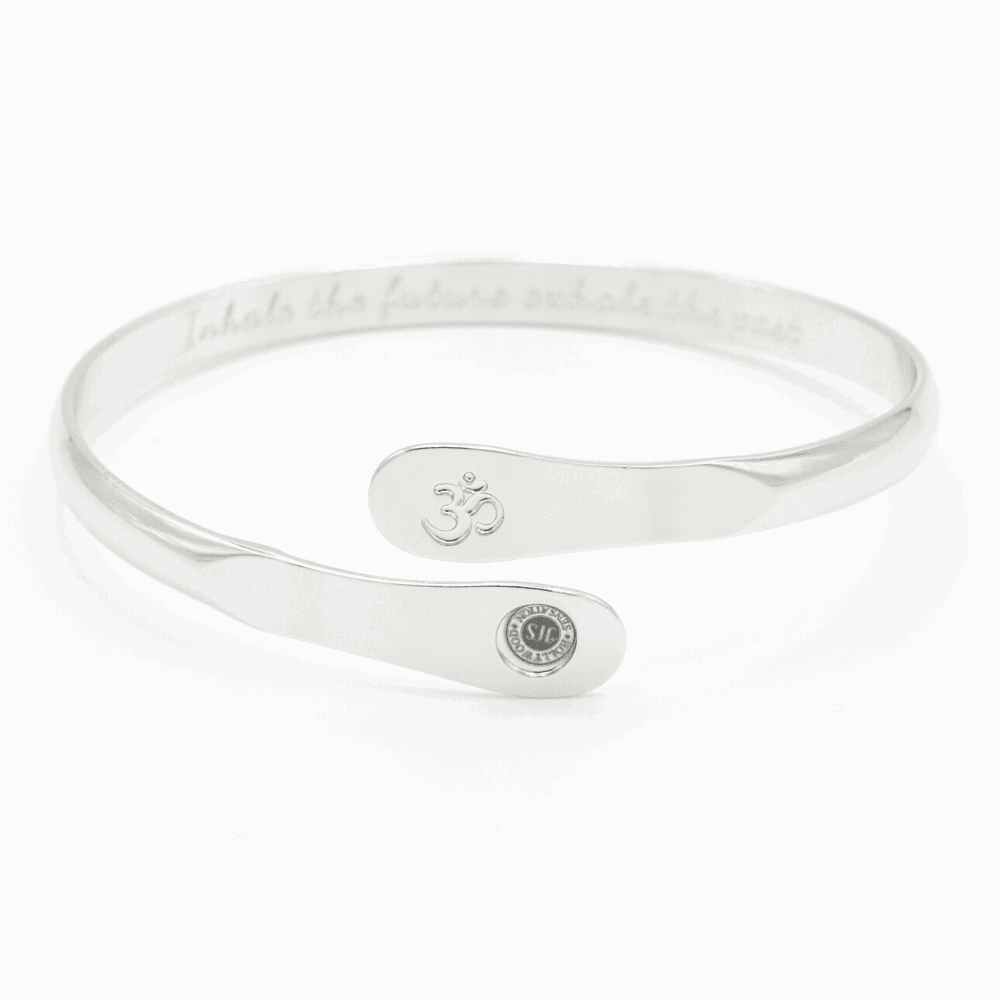 Silver yoga bracelet with engraved Om symbol plate and small round logo on side