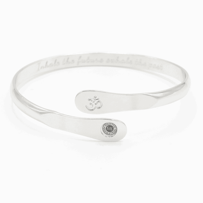 Silver yoga bracelet with engraved Om symbol plate and small round logo on side